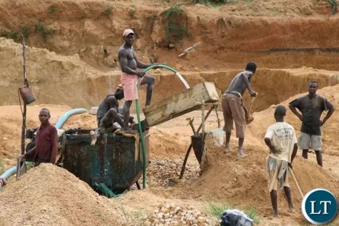 A small-scale gold miner panning for gold in Zimbabwe